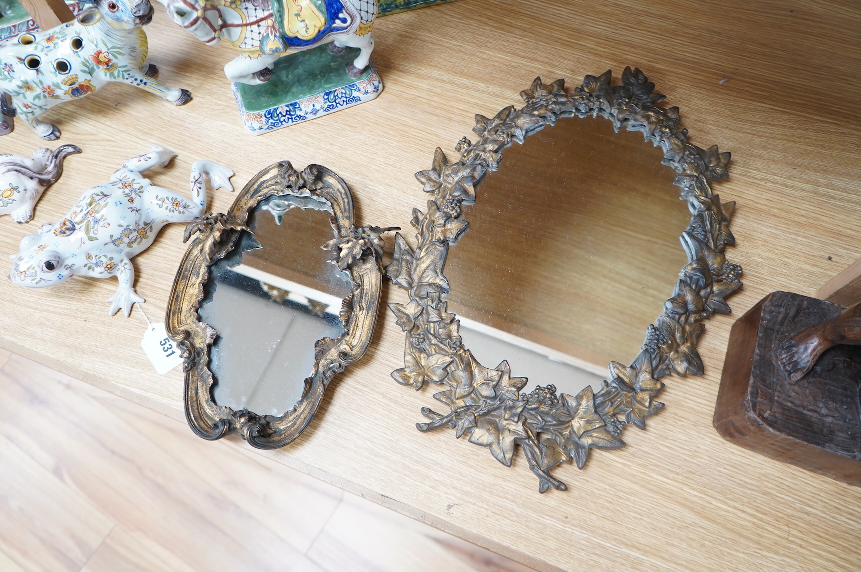 Two ornate oval gilt metal framed wall mirrors, largest 49cm